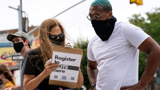 A volunteer with Brooklyn Voters Alliance registers a New York resident to vote in September. (Robert Nickelsberg/Getty Images)